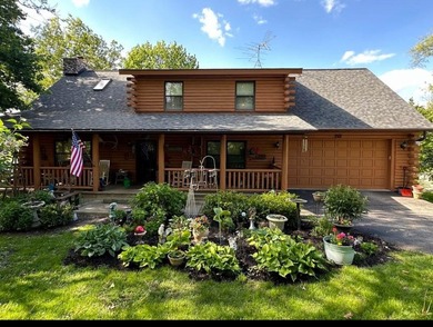 Welcome to this beautiful waterfront log home tucked away on a - photo 1