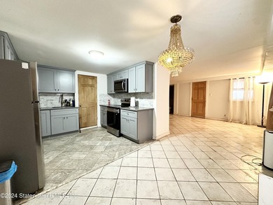 Welcome to this charming two-family detached home located in the - photo 3
