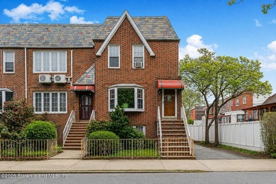 Located at 1879 Haring Street, this full brick end-unit - photo 1