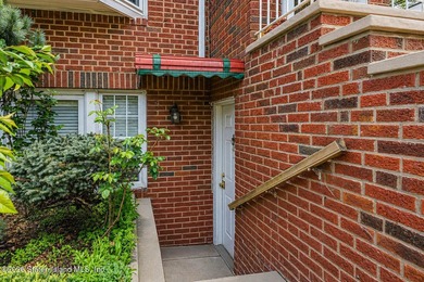 Located at 1879 Haring Street, this full brick end-unit - photo 5