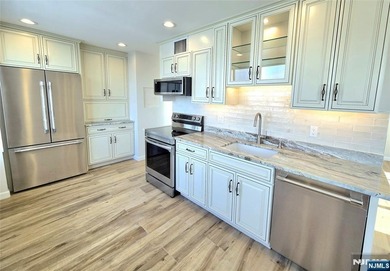 Step inside this Stunning, Custom, Top Floor Corner Unit and