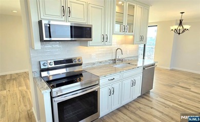 Step inside this Stunning, Custom, Top Floor Corner Unit and