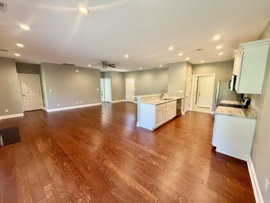 The spacious, open floor plan includes hardwood flooring, gas - photo 2