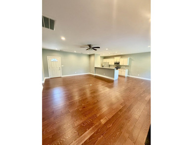 The spacious, open floor plan includes hardwood flooring, gas - photo 3
