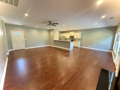The spacious, open floor plan includes hardwood flooring, gas - photo 4