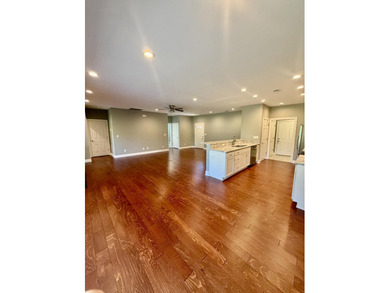 The spacious, open floor plan includes hardwood flooring, gas - photo 5