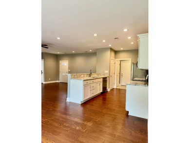 The spacious, open floor plan includes hardwood flooring, gas - photo 8
