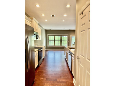The spacious, open floor plan includes hardwood flooring, gas - photo 9