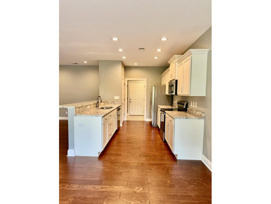 The spacious, open floor plan includes hardwood flooring, gas - photo 10