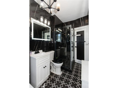 Welcome to this well-maintained brick one-family home offering - photo 7