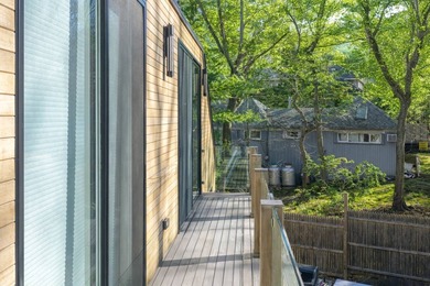 Just moments from the beach, this architecturally striking East - photo 5