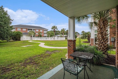 Enjoy effortless coastal living in this first floor, end-unit