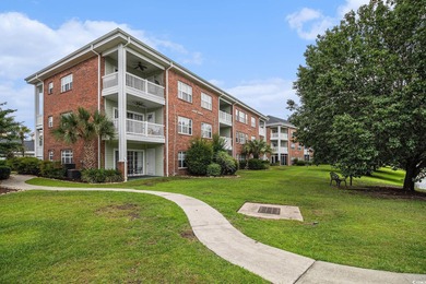 Enjoy effortless coastal living in this first floor, end-unit