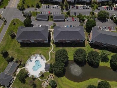 Enjoy effortless coastal living in this first floor, end-unit