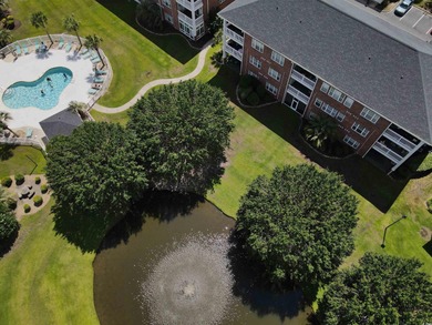 Enjoy effortless coastal living in this first floor, end-unit