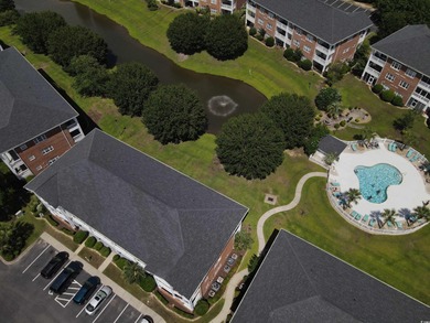 Enjoy effortless coastal living in this first floor, end-unit