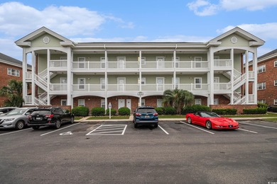 Enjoy effortless coastal living in this first floor, end-unit