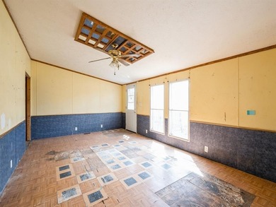 Manufactured home in need of repairs. Nice corner lot, just shy