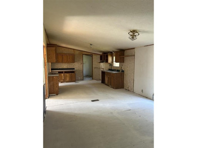 Manufactured home in need of repairs. Nice corner lot, just shy