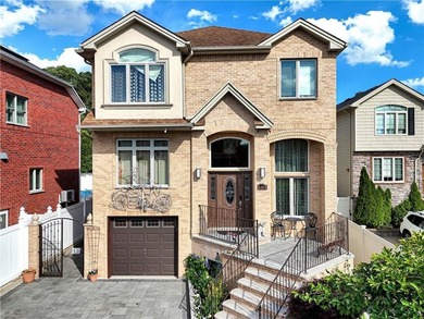 Built in 2013, this detached two-family home with brick front - photo 2