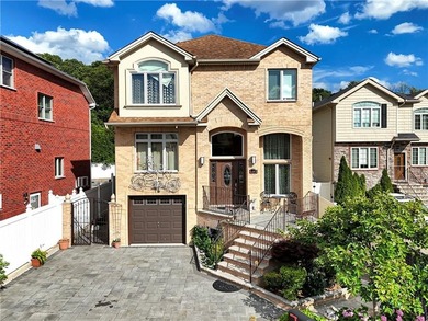 Built in 2013, this detached two-family home with brick front - photo 4