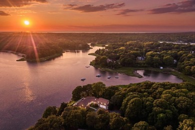 Set on a rare peninsula overlooking 27 acres of protected - photo 5
