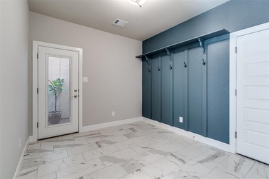 This jewel in the gated Merion community offers refined