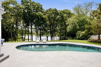 This meticulously renovated waterfront Cape on the bay is - photo 6