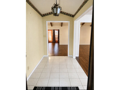 Nestled on a beautifully landscaped corner lot in the - photo 2