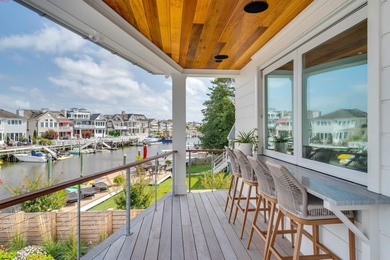Welcome to 55 Walnut Road, a stunning bayfront masterpiece. This