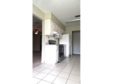 This 3-bedroom, 2-bath home with a garage and fenced backyard - photo 5