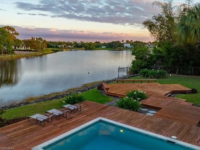 Set behind a curtain of mature landscaping and shimmering water - photo 3