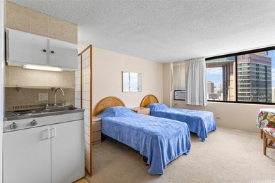 Situated in the heart of Waikiki, this high-floor unit at - photo 2