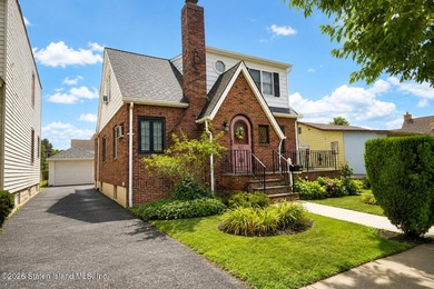 A detached two family home set on an expansive, street to street
