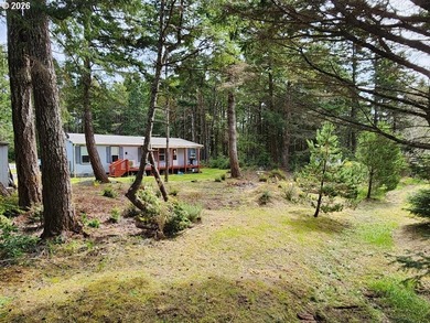 Tucked away among the trees on 1.16 private acres with a Large - photo 3