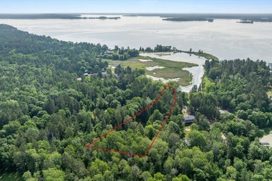 Nestled among mature pines and along a peaceful channel, the - photo 1