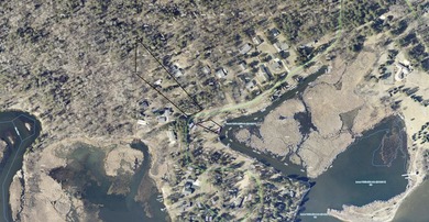 Nestled among mature pines and along a peaceful channel, the - photo 2