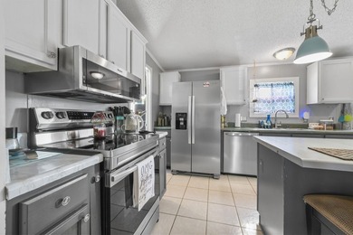 Welcome to 6043 East West Way, an inviting coastal home nestled - photo 2
