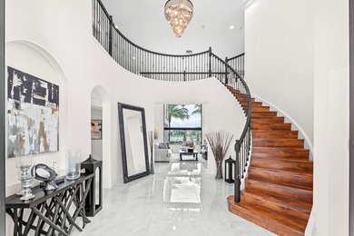 Beyond double entry doors, a remodeled iron staircase frames - photo 5
