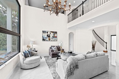 Beyond double entry doors, a remodeled iron staircase frames - photo 9