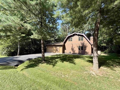 Nestled on a beautifully wooded lot in the gated community of - photo 1