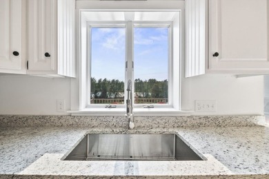 Welcome to 675 River Road, a rare riverside property set on - photo 13