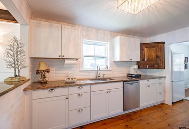Main lake waterfront with private dock, updated interior, and - photo 10