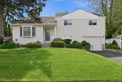 A charming expanded 3-bedroom, 2.5-bath split-level home located - photo 1