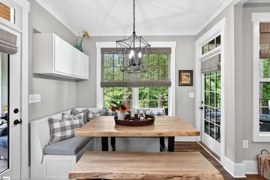 An oversized covered front porch with stained wood ceilings sets - photo 13