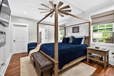 An oversized covered front porch with stained wood ceilings sets - photo 16