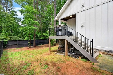 An oversized covered front porch with stained wood ceilings sets - photo 33