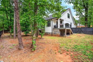 An oversized covered front porch with stained wood ceilings sets - photo 34