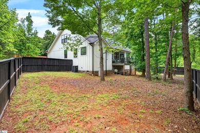 An oversized covered front porch with stained wood ceilings sets - photo 35