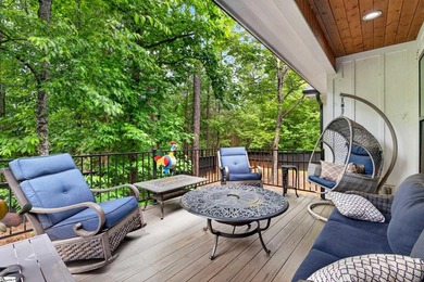 An oversized covered front porch with stained wood ceilings sets - photo 38